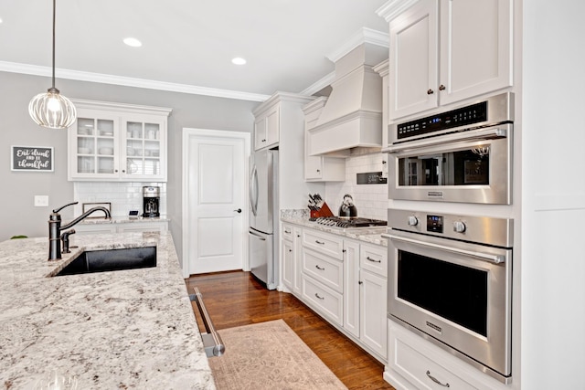 2003 Imagine Cir, Spring Hill, TN 37174 - kitchen with stainless steel appliances, white cabinetry, glass insert cabinets, backsplash, and crown molding