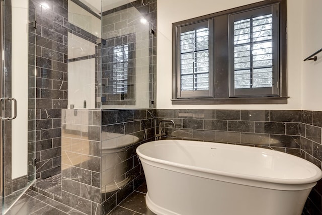 325 Fairpark Ct, Franklin, TN 37064 - bathroom with a freestanding tub, tile walls, and a stall shower