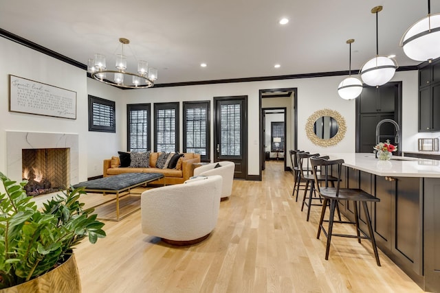 325 Fairpark Ct, Franklin, TN 37064 - living room with ornamental molding, a premium fireplace, light wood-type flooring, a chandelier, and recessed lighting