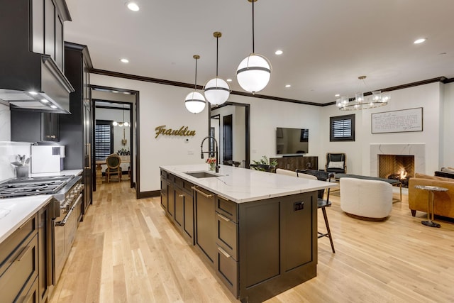 325 Fairpark Ct, Franklin, TN 37064 - kitchen featuring crown molding, light wood-style flooring, a chandelier, light stone counters, and range with two ovens
