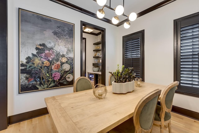 325 Fairpark Ct, Franklin, TN 37064 - dining space featuring light wood-type flooring, a chandelier, wine cooler, and ornamental molding