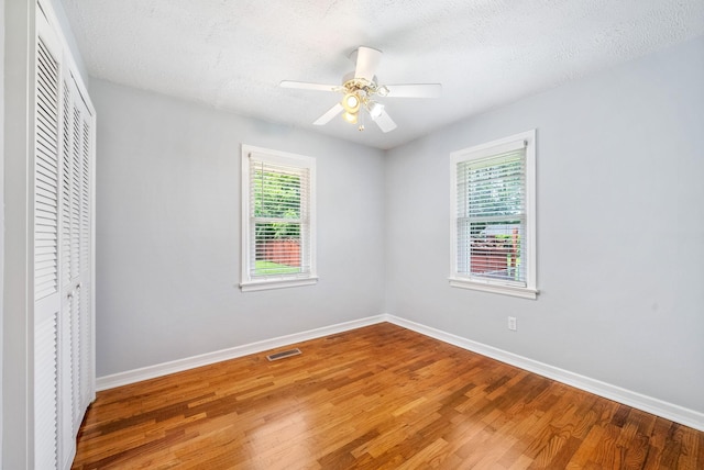 3509 Lafayette Rd, Hopkinsville, KY 42240 - unfurnished bedroom featuring a closet, light wood-type flooring, ceiling fan, and a textured ceiling
