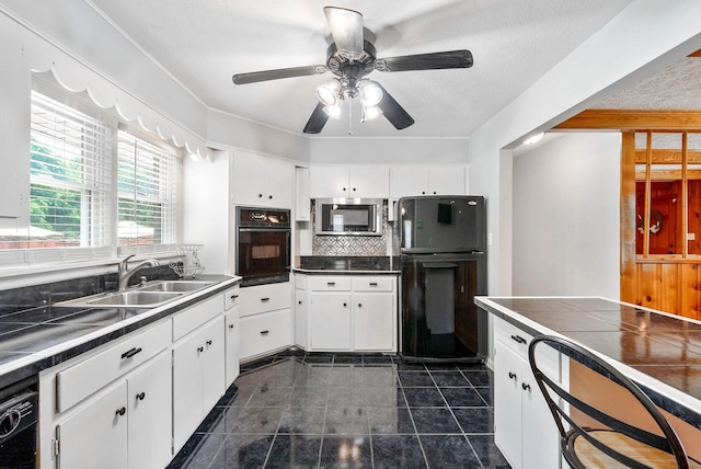 3509 Lafayette Rd, Hopkinsville, KY 42240 - kitchen with black appliances, white cabinets, and ceiling fan