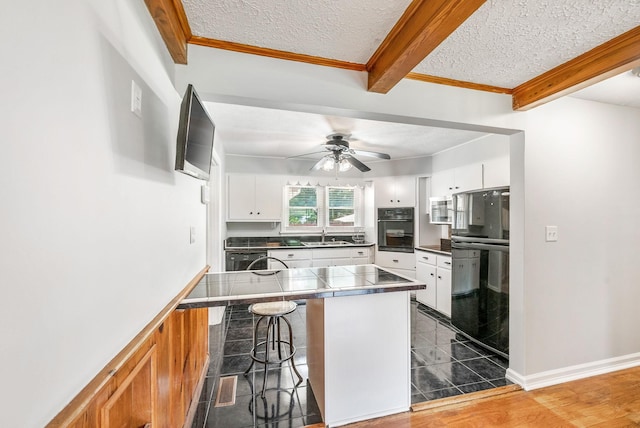 3509 Lafayette Rd, Hopkinsville, KY 42240 - kitchen featuring a breakfast bar, white cabinets, fridge, beamed ceiling, and a peninsula