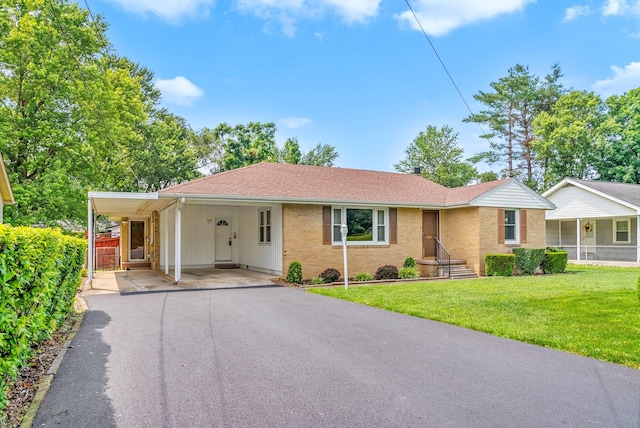3509 Lafayette Rd, Hopkinsville, KY 42240 - single story home featuring a carport, brick siding, a front yard, driveway, and a shingled roof