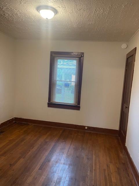 764 Center St, Lewisburg, TN 37091 - unfurnished room featuring dark wood-style floors and a textured ceiling