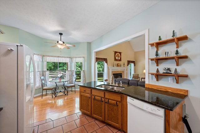 191 Spicer Rd, Burns, TN 37029 - kitchen featuring white appliances, ceiling fan, dark stone countertops, a tile fireplace, and open shelves