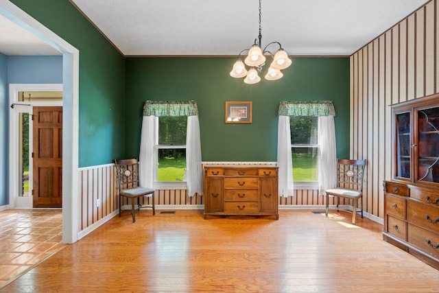 191 Spicer Rd, Burns, TN 37029 - dining area with healthy amount of natural light, a chandelier, light wood-type flooring, and wallpapered walls