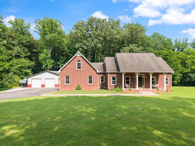 191 Spicer Rd, Burns, TN 37029 - view of front of home with covered porch, a front yard, an outdoor structure, brick siding, and a detached garage