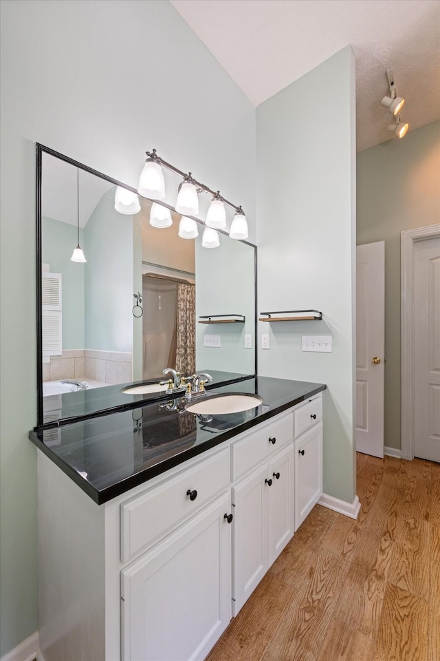 191 Spicer Rd, Burns, TN 37029 - full bathroom with wood finished floors, vanity, and a shower with shower curtain
