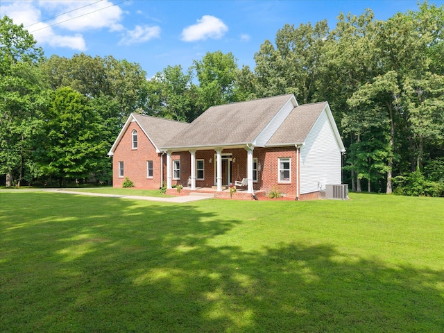 191 Spicer Rd, Burns, TN 37029 - view of front of property with a porch, a front lawn, brick siding, and view of wooded area