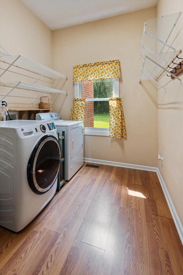 191 Spicer Rd, Burns, TN 37029 - laundry area with washer and clothes dryer and wood finished floors