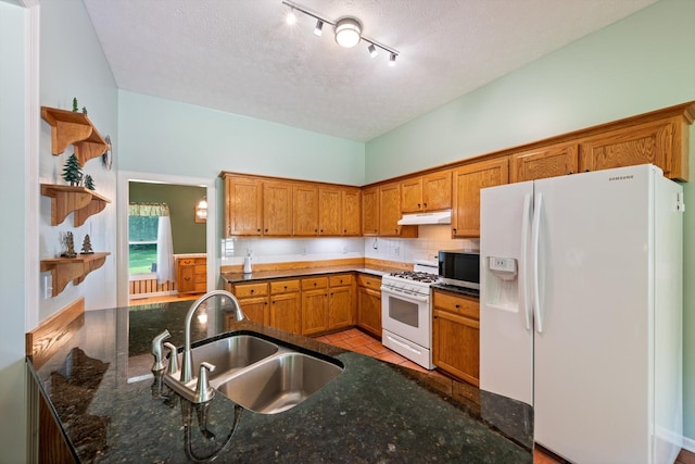 191 Spicer Rd, Burns, TN 37029 - kitchen featuring white appliances, under cabinet range hood, open shelves, brown cabinets, and dark stone counters