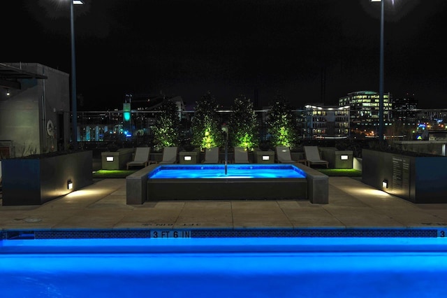 1212 Laurel St Unit 2009, Nashville, TN 37203 - pool at night with a jacuzzi and a patio area
