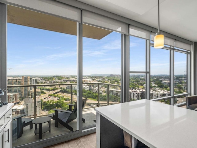 1212 Laurel St Unit 2009, Nashville, TN 37203 - sunroom with a wall of windows, wood finished floors, and a view of city