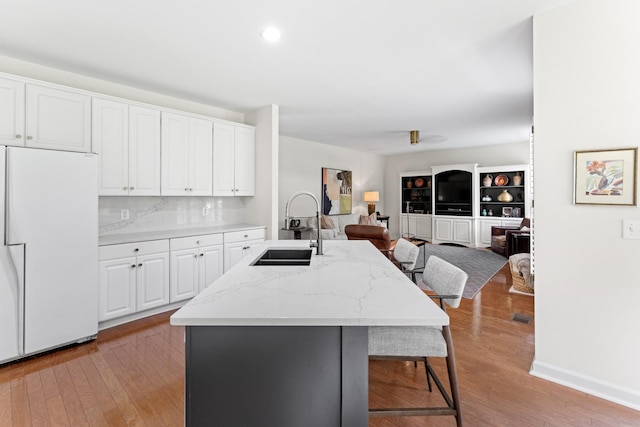 4016 Brandywine Pointe Blvd, Old Hickory, TN 37138 - kitchen with fridge, an island with sink, open floor plan, a breakfast bar area, and light wood-style flooring