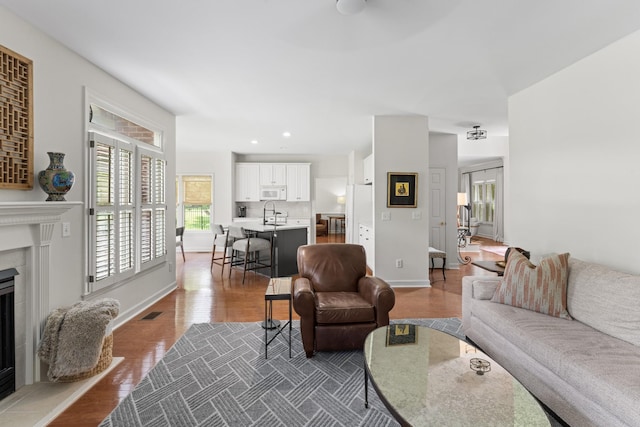 4016 Brandywine Pointe Blvd, Old Hickory, TN 37138 - living area featuring a fireplace with raised hearth, wood finished floors, a ceiling fan, and recessed lighting