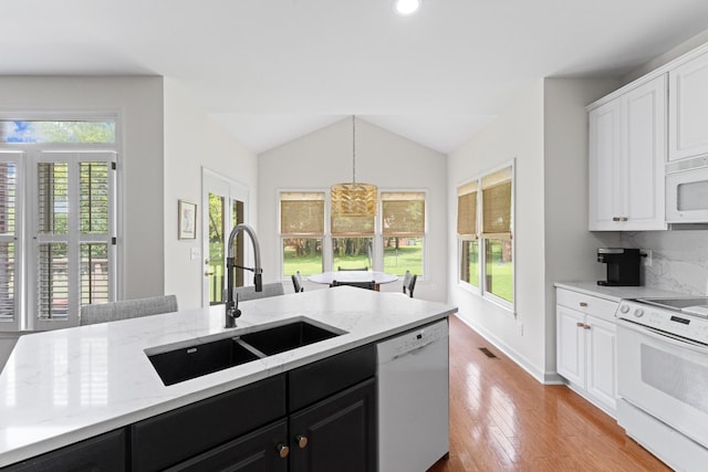4016 Brandywine Pointe Blvd, Old Hickory, TN 37138 - kitchen featuring white appliances, dark cabinets, white cabinets, lofted ceiling, and light stone counters