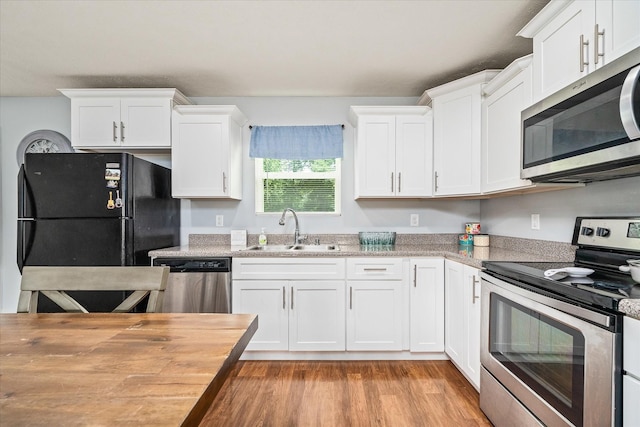 258 Green Meadow Dr, Smithville, TN 37166 - kitchen with appliances with stainless steel finishes, white cabinets, and light wood finished floors