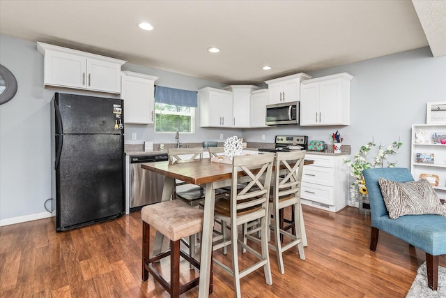 258 Green Meadow Dr, Smithville, TN 37166 - kitchen with stainless steel appliances, dark wood-style floors, white cabinetry, and recessed lighting
