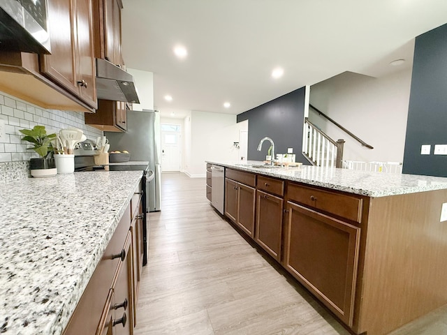 101 Percheron Pl, Smyrna, TN 37167 - kitchen featuring range with electric cooktop, stainless steel dishwasher, under cabinet range hood, a center island with sink, and light stone countertops