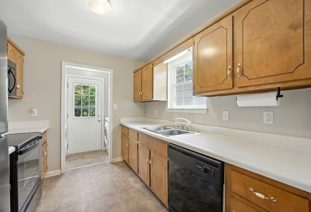 1812 Carneal Ln, Oak Grove, KY 42262 - kitchen with dishwasher, range with electric cooktop, light countertops, washer / dryer, and brown cabinetry