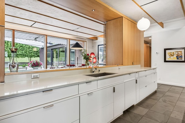 1091 Lynnwood Blvd, Nashville, TN 37215 - kitchen with white cabinetry, light countertops, pendant lighting, and dark tile patterned flooring