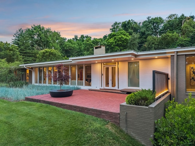 1091 Lynnwood Blvd, Nashville, TN 37215 - back of property with french doors, a chimney, a patio area, a yard, and an outdoor fire pit