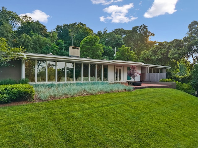 1091 Lynnwood Blvd, Nashville, TN 37215 - rear view of property with a sunroom, a lawn, and a chimney