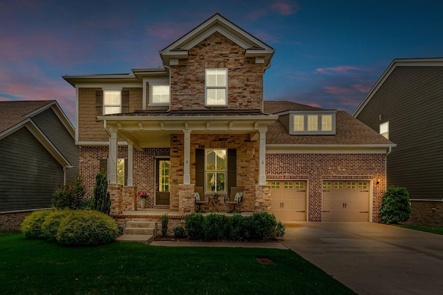 1074 Amelia Park Dr, Franklin, TN 37067 - view of front of house with a porch, concrete driveway, brick siding, stone siding, and an attached garage
