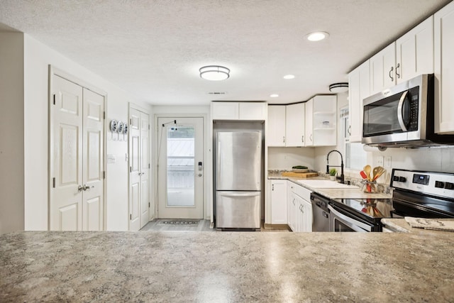 617 Still Point Rd, Smithville, TN 37166 - kitchen featuring appliances with stainless steel finishes, open shelves, white cabinetry, recessed lighting, and a textured ceiling
