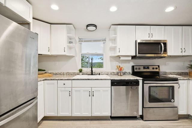 617 Still Point Rd, Smithville, TN 37166 - kitchen featuring appliances with stainless steel finishes, open shelves, white cabinets, light wood-style floors, and recessed lighting