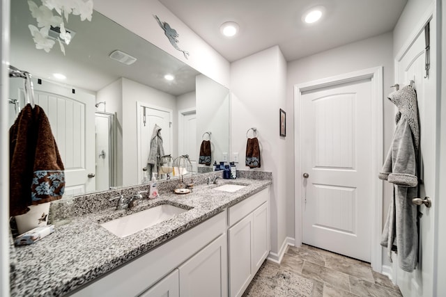 701 Dallas Dr, Columbia, TN 38401 - bathroom with double vanity, a shower stall, and stone finish flooring