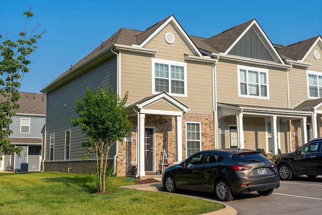701 Dallas Dr, Columbia, TN 38401 - townhome / multi-family property featuring board and batten siding, a front lawn, and stone siding