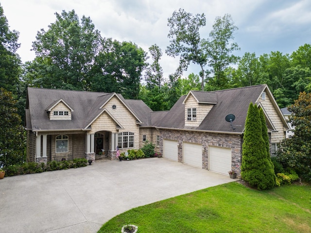 90 Grandview Lake Rd, Estill Springs, TN 37330 - craftsman inspired home with stone siding, concrete driveway, a front lawn, an attached garage, and roof with shingles