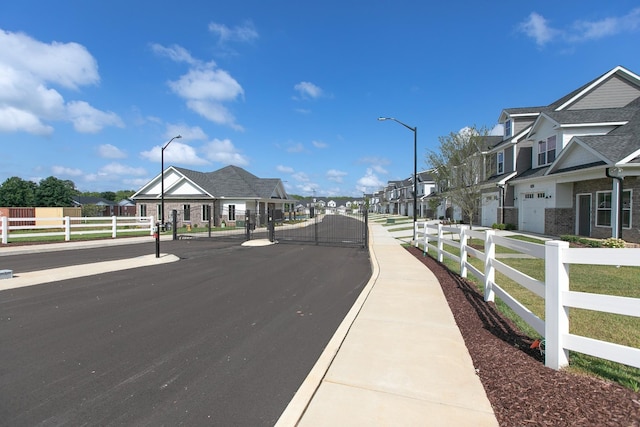 528 Haviture Way, Murfreesboro, TN 37129 - view of asphalt street with street lighting, sidewalks, a residential view, and a gate
