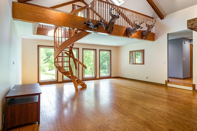 5141 Tranham Rd, Whites Creek, TN 37189 - unfurnished living room with stairway, healthy amount of natural light, beam ceiling, high vaulted ceiling, and wood finished floors