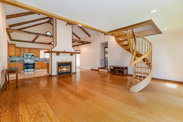 5141 Tranham Rd, Whites Creek, TN 37189 - unfurnished living room with recessed lighting, stairway, light wood-style floors, and a glass covered fireplace