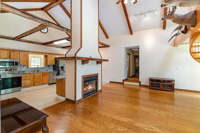 5141 Tranham Rd, Whites Creek, TN 37189 - living room with a glass covered fireplace, light wood-style flooring, beamed ceiling, high vaulted ceiling, and ceiling fan