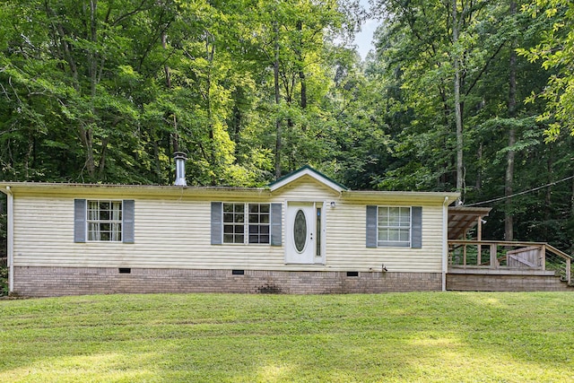 5141 Tranham Rd, Whites Creek, TN 37189 - manufactured / mobile home featuring crawl space, a front yard, a wooden deck, and a forest view