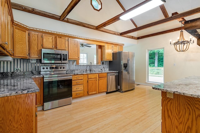 5141 Tranham Rd, Whites Creek, TN 37189 - kitchen with appliances with stainless steel finishes, beamed ceiling, light wood finished floors, backsplash, and a chandelier