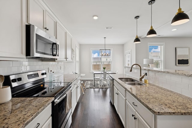 9007 Outpost Dr, Spring Hill, TN 37174 - kitchen with appliances with stainless steel finishes, dark wood-style flooring, decorative backsplash, healthy amount of natural light, and recessed lighting