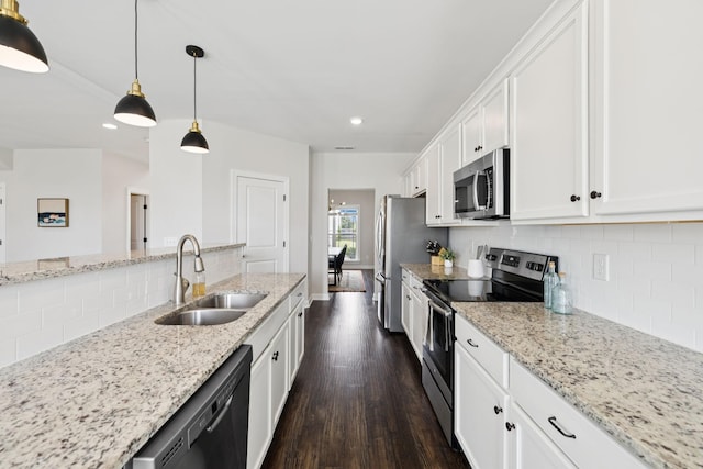 9007 Outpost Dr, Spring Hill, TN 37174 - kitchen with stainless steel appliances, tasteful backsplash, dark wood-type flooring, white cabinetry, and recessed lighting