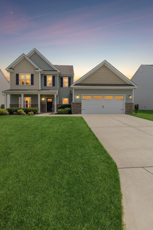 9007 Outpost Dr, Spring Hill, TN 37174 - craftsman inspired home featuring a yard, concrete driveway, brick siding, a porch, and board and batten siding