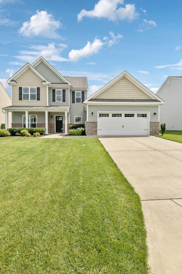 9007 Outpost Dr, Spring Hill, TN 37174 - craftsman inspired home with brick siding, a front yard, board and batten siding, and concrete driveway