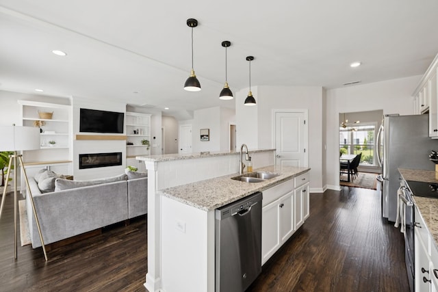 9007 Outpost Dr, Spring Hill, TN 37174 - kitchen featuring appliances with stainless steel finishes, a center island with sink, dark wood finished floors, white cabinetry, and recessed lighting