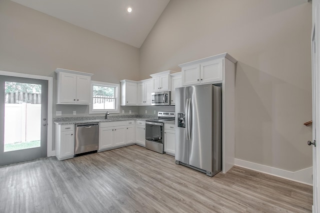 514 Haviture Way, Murfreesboro, TN 37129 - kitchen featuring stainless steel appliances, high vaulted ceiling, white cabinets, light wood-type flooring, and light stone countertops