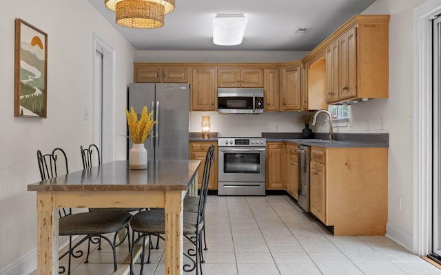 750 S Seminole Dr, Chattanooga, TN 37412 - kitchen featuring appliances with stainless steel finishes, dark countertops, and light tile patterned flooring