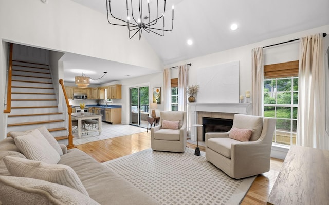 750 S Seminole Dr, Chattanooga, TN 37412 - living room featuring stairway, a chandelier, a fireplace, light wood-style flooring, and recessed lighting