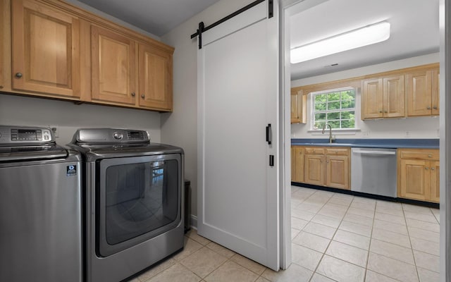 750 S Seminole Dr, Chattanooga, TN 37412 - laundry area with washing machine and dryer, cabinet space, light tile patterned floors, and a barn door